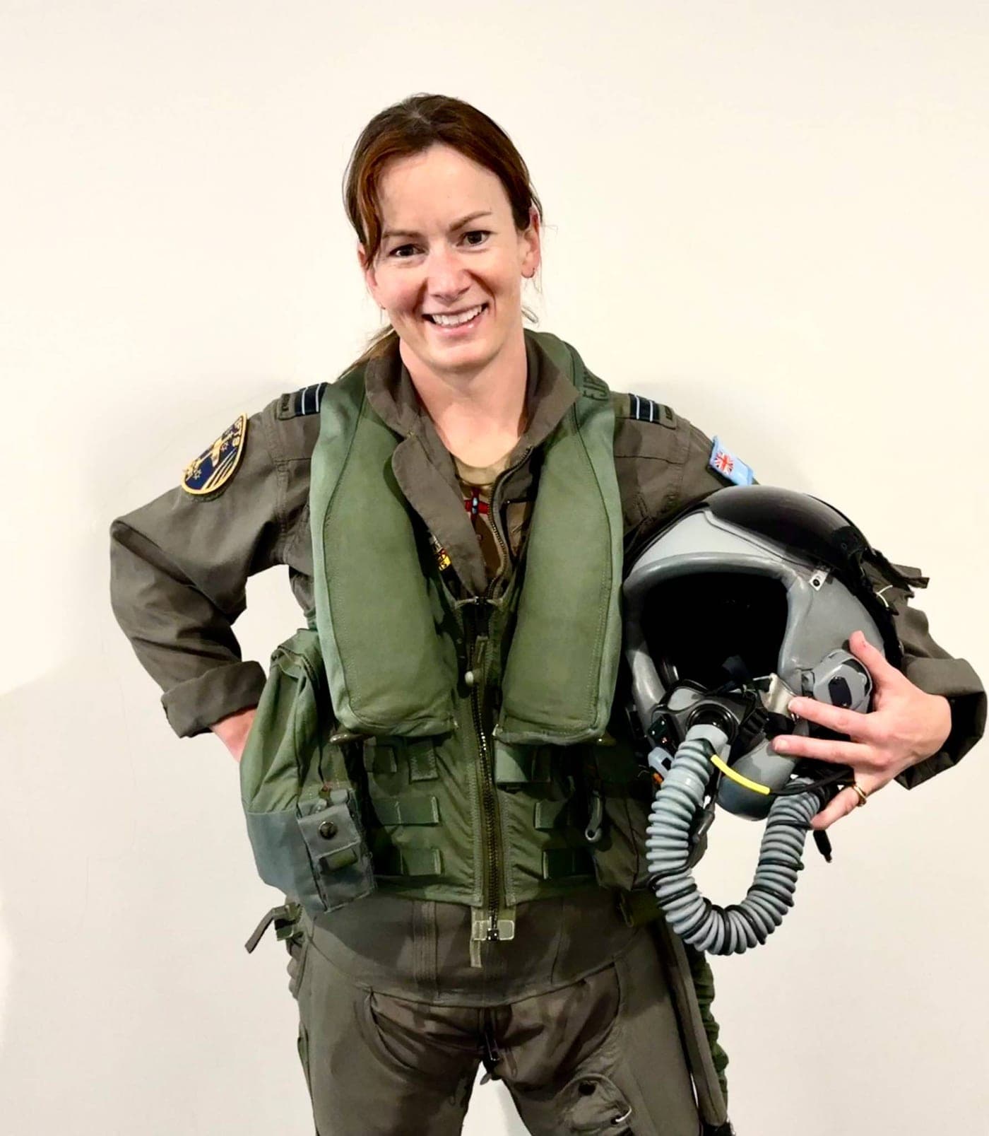 A speaker in flight gear, carrying a helmet