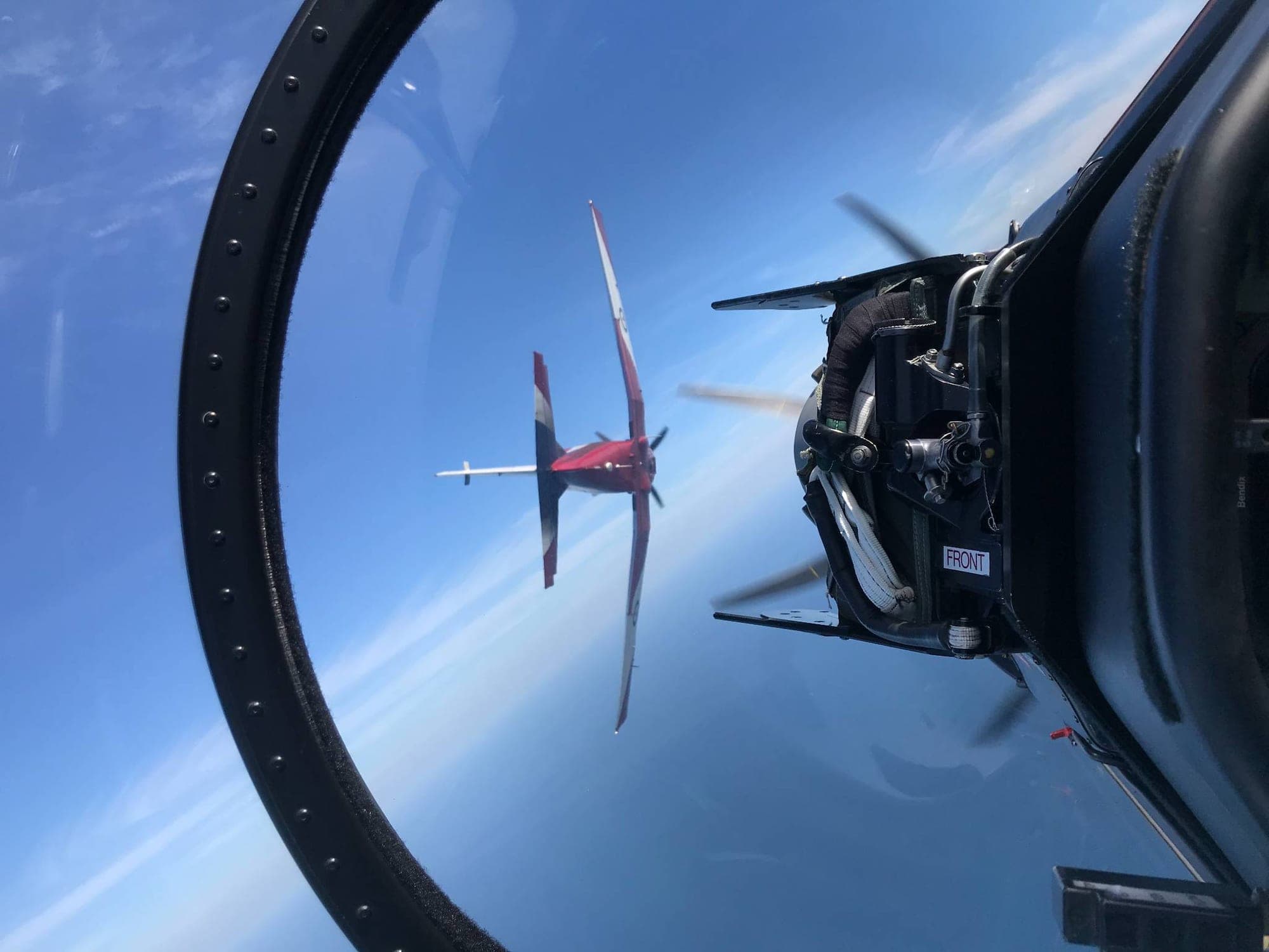 A wingman holding position through a manoeuvre, seen from the next aircraft