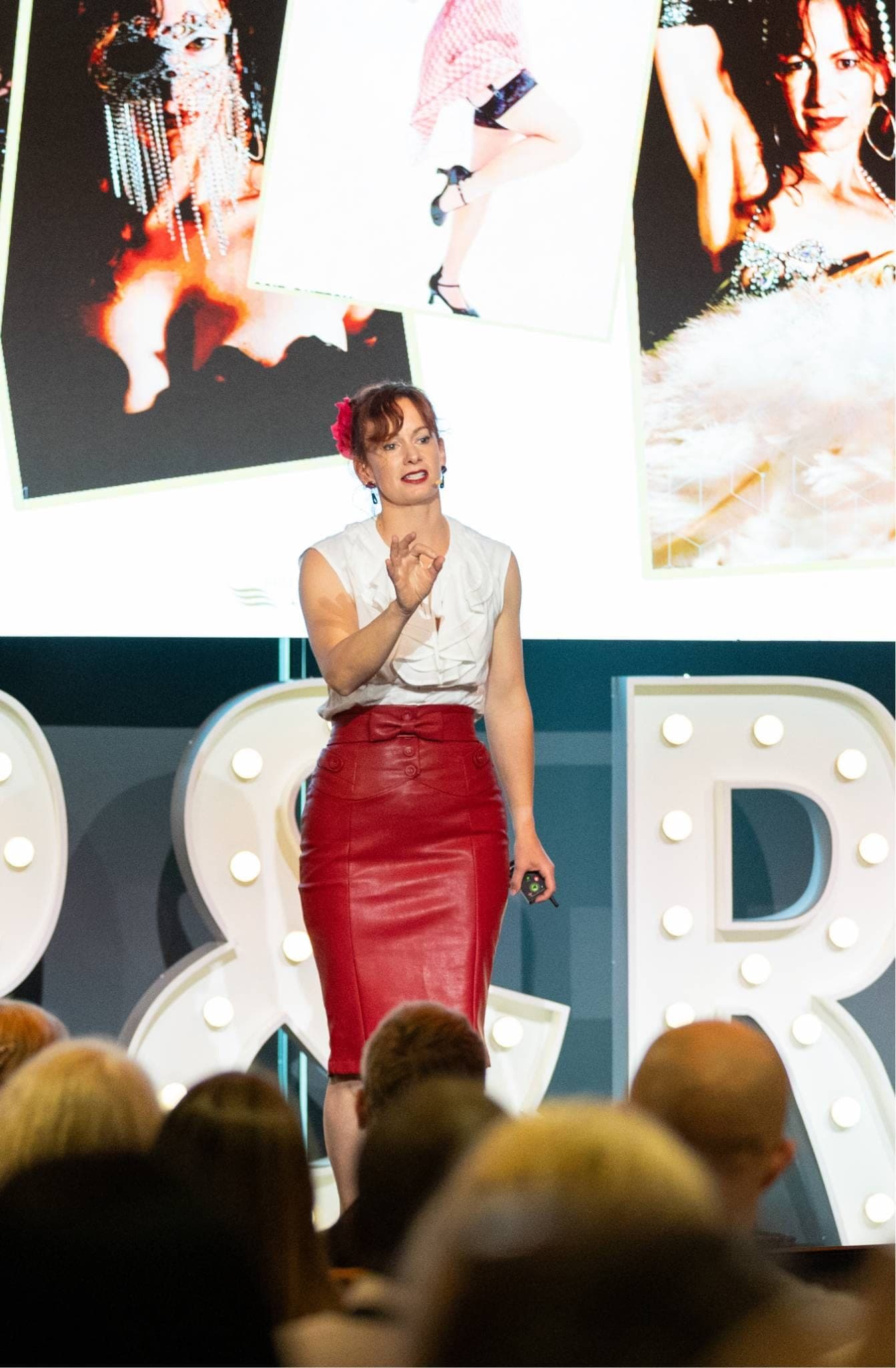 A keynote in progress, photographs projected on the screen behind the stage